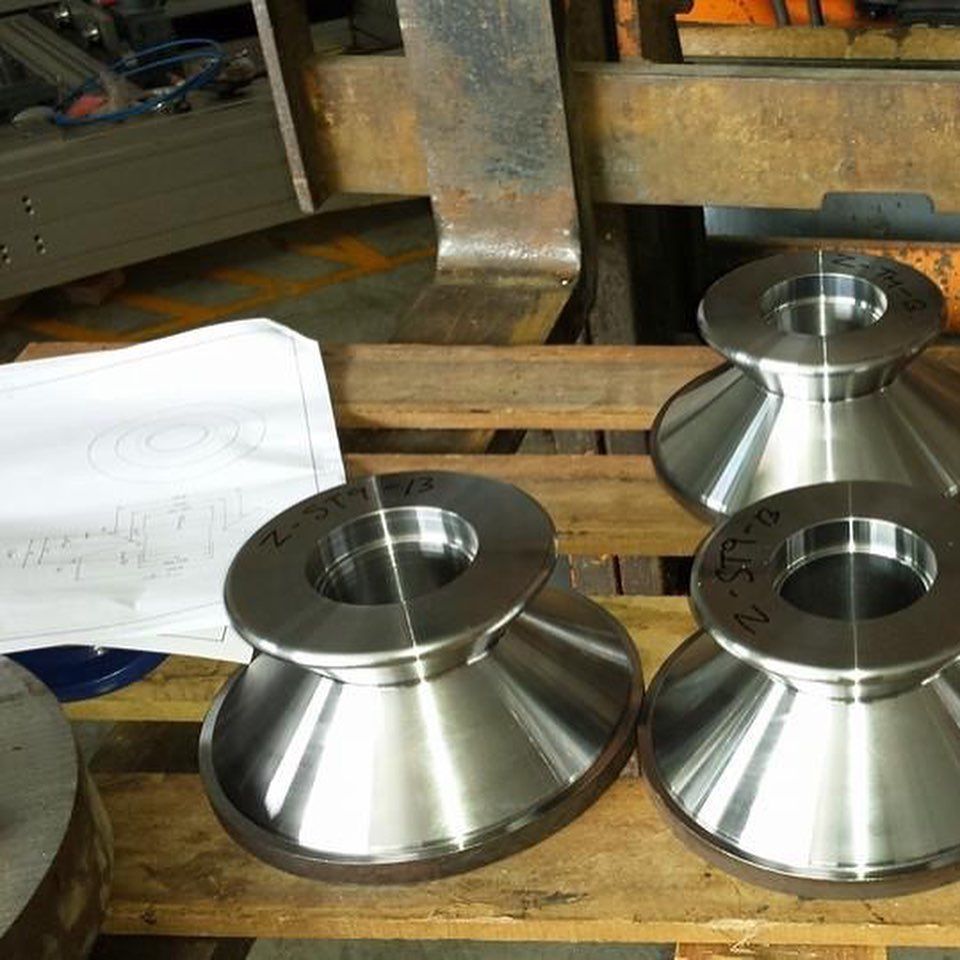 A Bunch Of Metal Pieces Are Sitting On A Wooden Pallet — D.E.M Solutions Pty Ltd In Caboolture, QLD