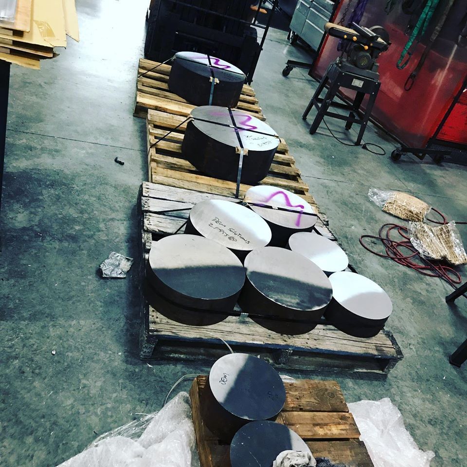 A Bunch Of Metal Pieces Are Sitting On Wooden Pallets — D.E.M Solutions Pty Ltd In Caboolture, QLD