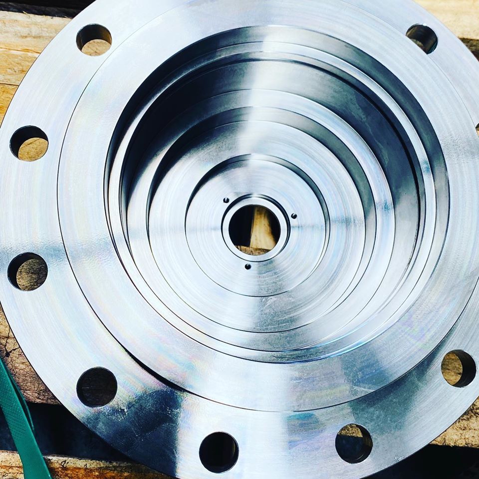 A Close Up Of A Metal Disc With Holes In It — D.E.M Solutions Pty Ltd In Caboolture, QLD