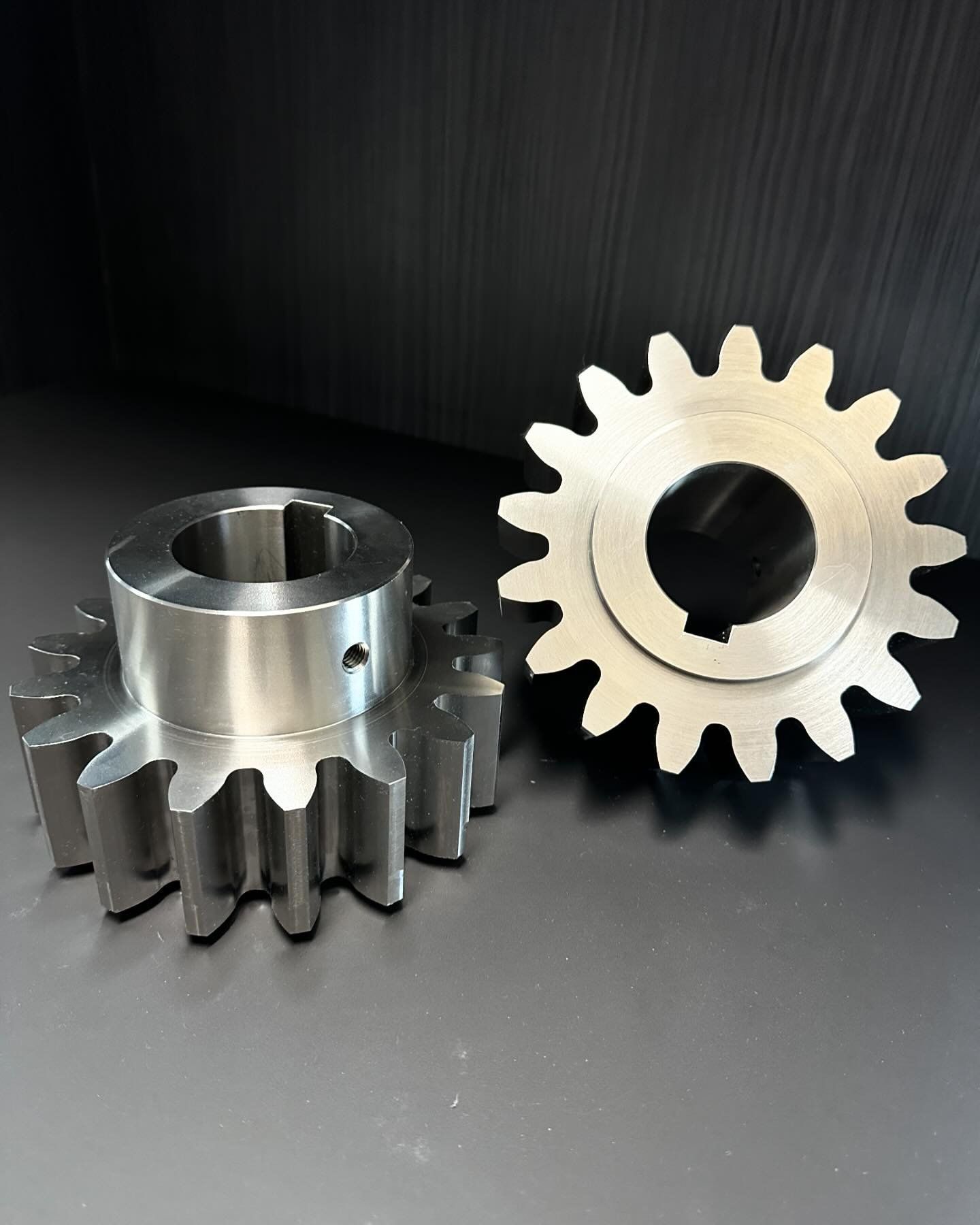 Two Metal Gears Are Sitting Next To Each Other On A Table — D.E.M Solutions Pty Ltd In Caboolture, QLD