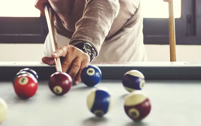 Person playing billiards