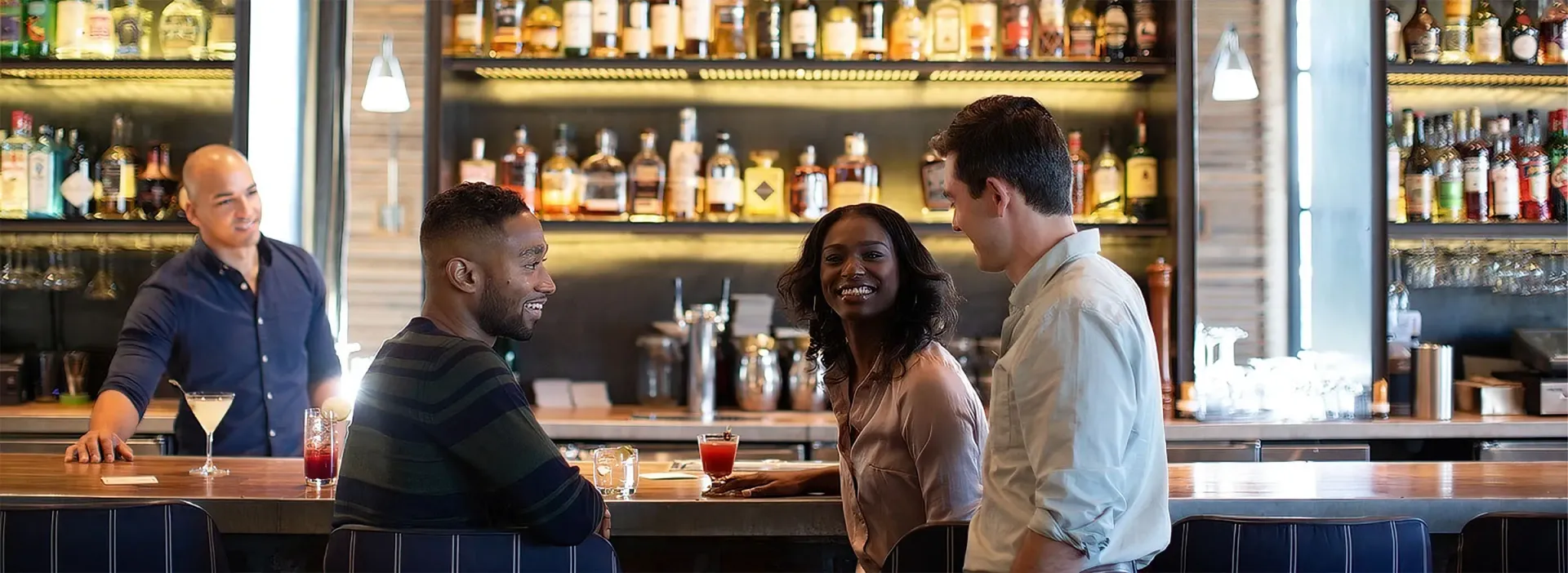 People enjoying drinks at the apartment complex bar.