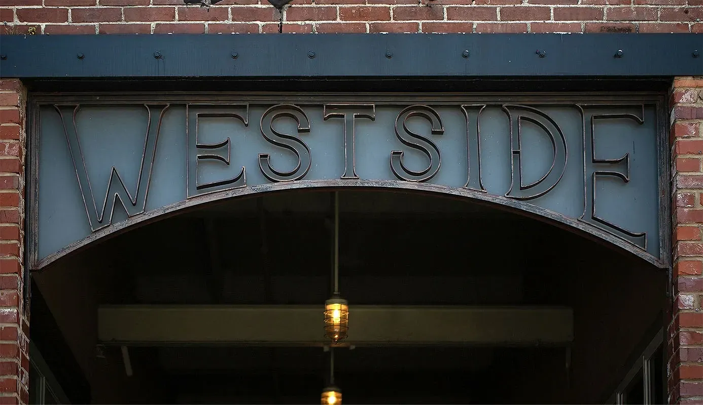 Westside property sign on brick building.
