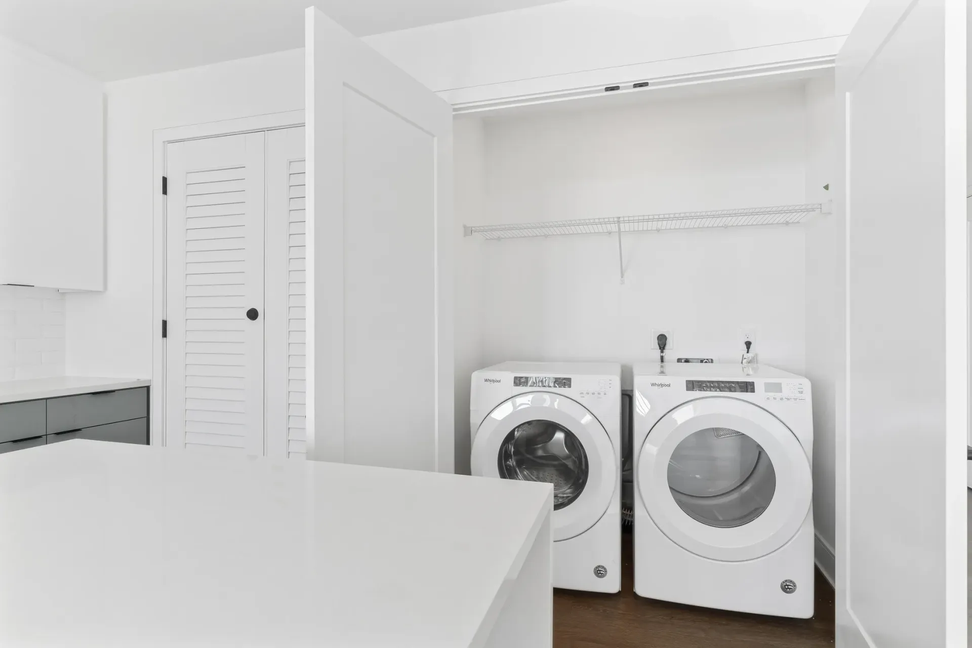 Stackable washer and dryer in a closet.