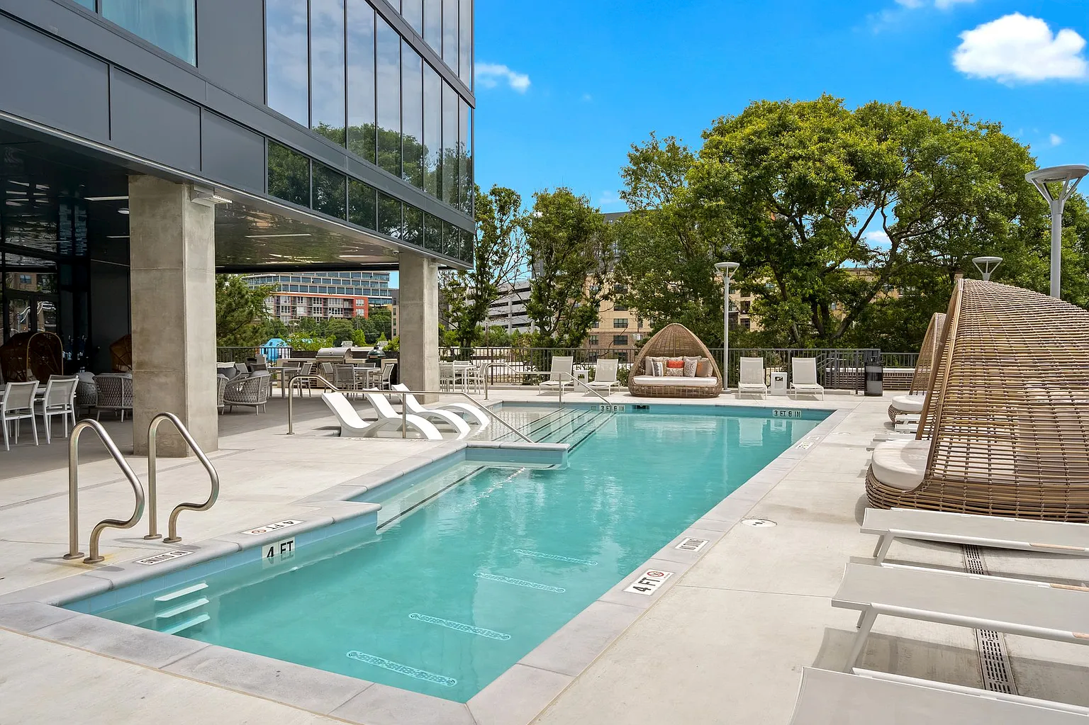 Gorgeous resort-style pool with lounge chairs on sundeck at Seven88.