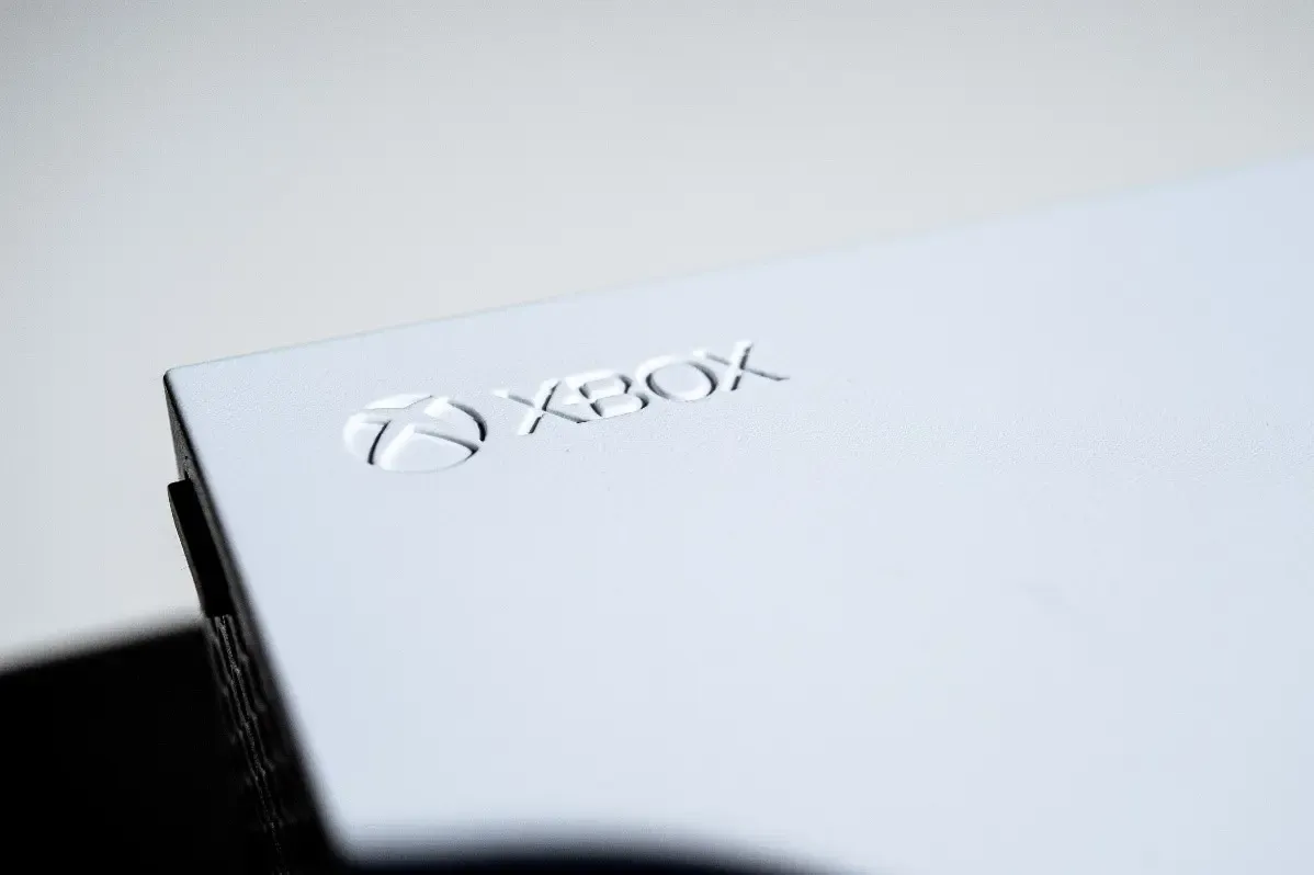 A close up of a white xbox box on a table.