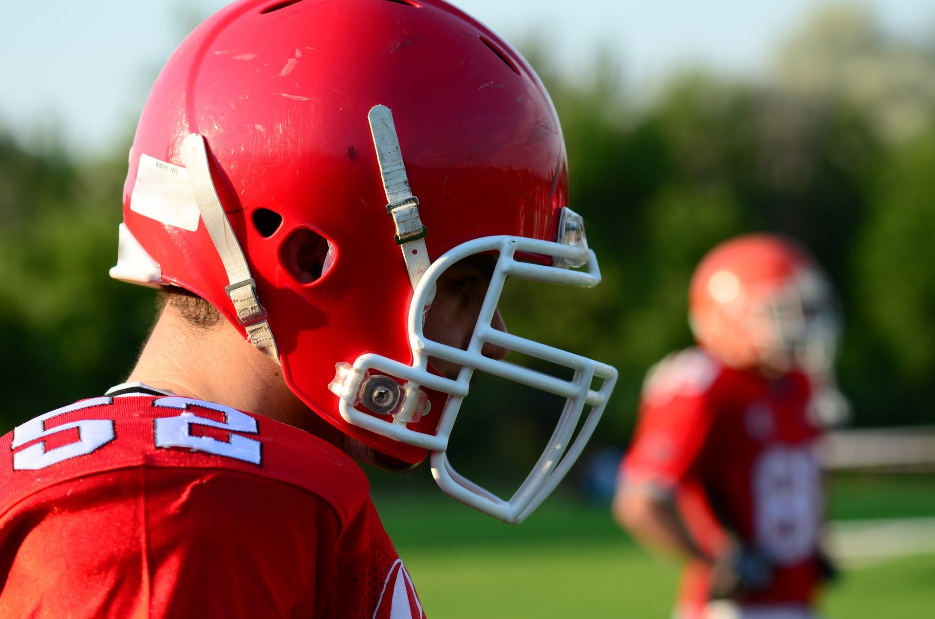 A football player wearing a red helmet with the number 5 on it