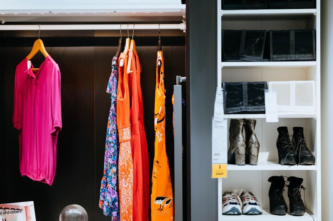 A reach-in closet transformed with custom shelving and drawers, showcasing neat stacks of clothes and organized accessories - custom closet cabinetry