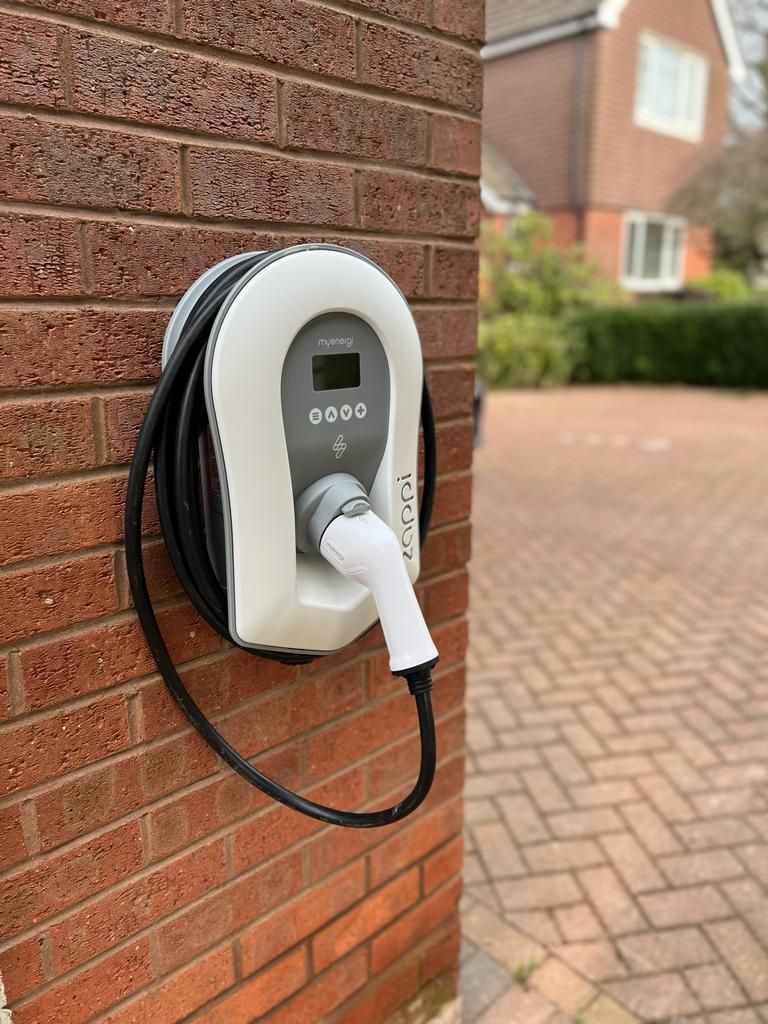 EV charger attached to a wall on a house