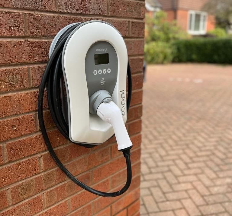EV charger fixed to a wall on a house