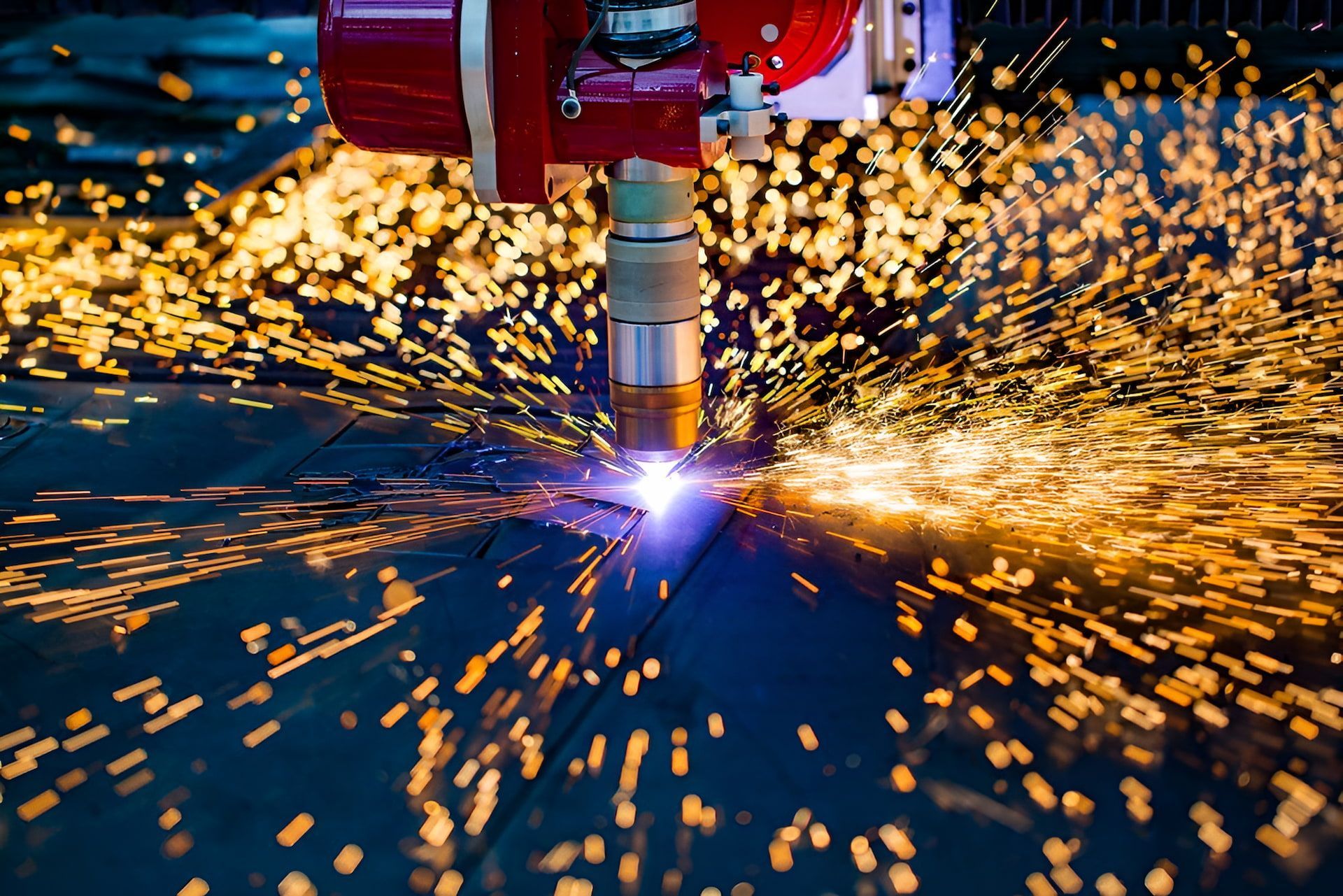 A Machine is Cutting a Piece of Metal With Sparks Coming Out of It — Mudgee Powder Coat Pty Ltd in Mudgee, NSW
