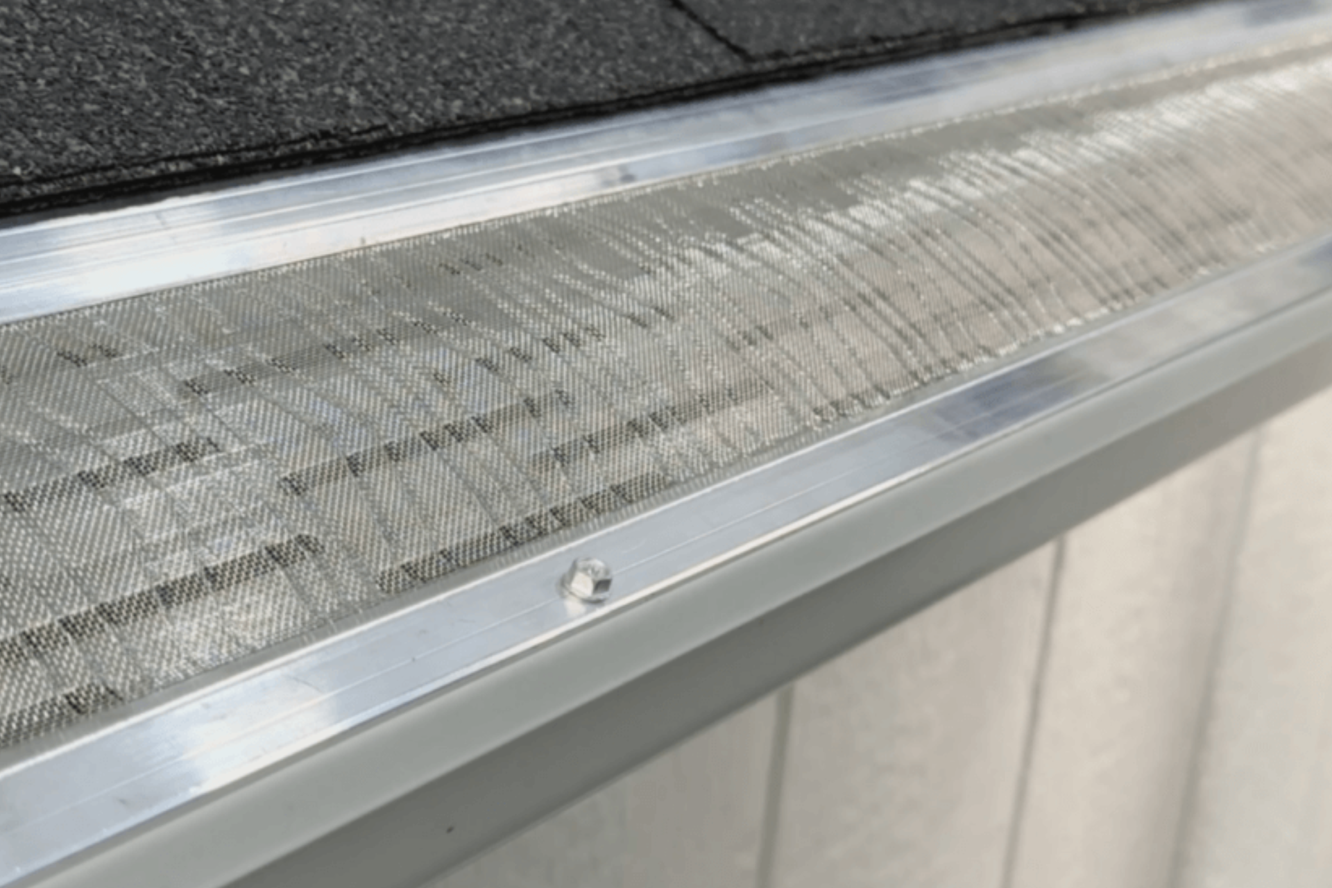 A close up of a gutter guard on a roof.
