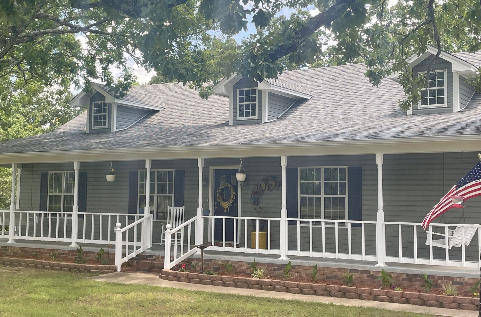 Exterior Portfolio Board & Batten vinyl siding in Bone. 5” seamless gutters, downspouts, and all trim in Linen