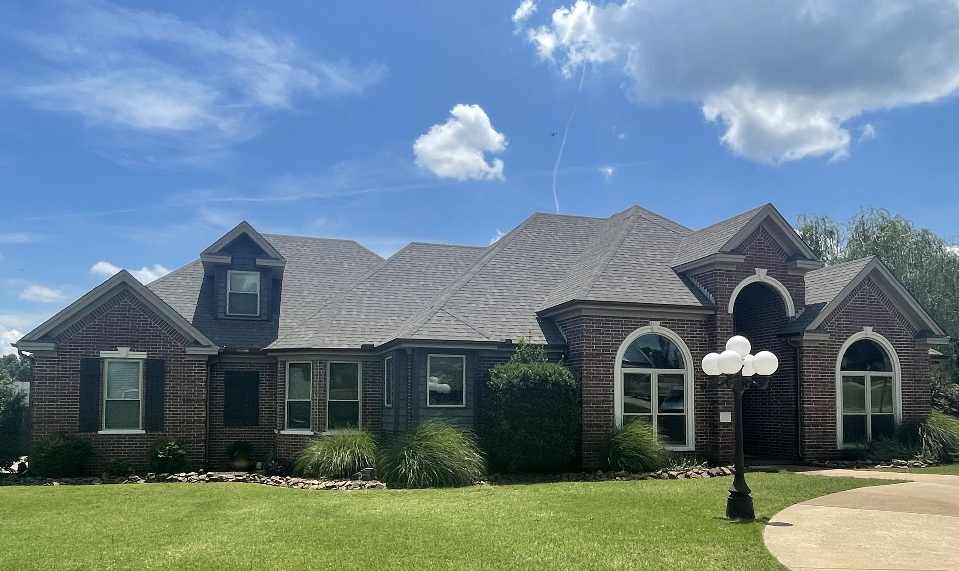 Royal Crest Dutchlap vinyl siding in Blue Gray. 5” seamless gutters and downspouts in white