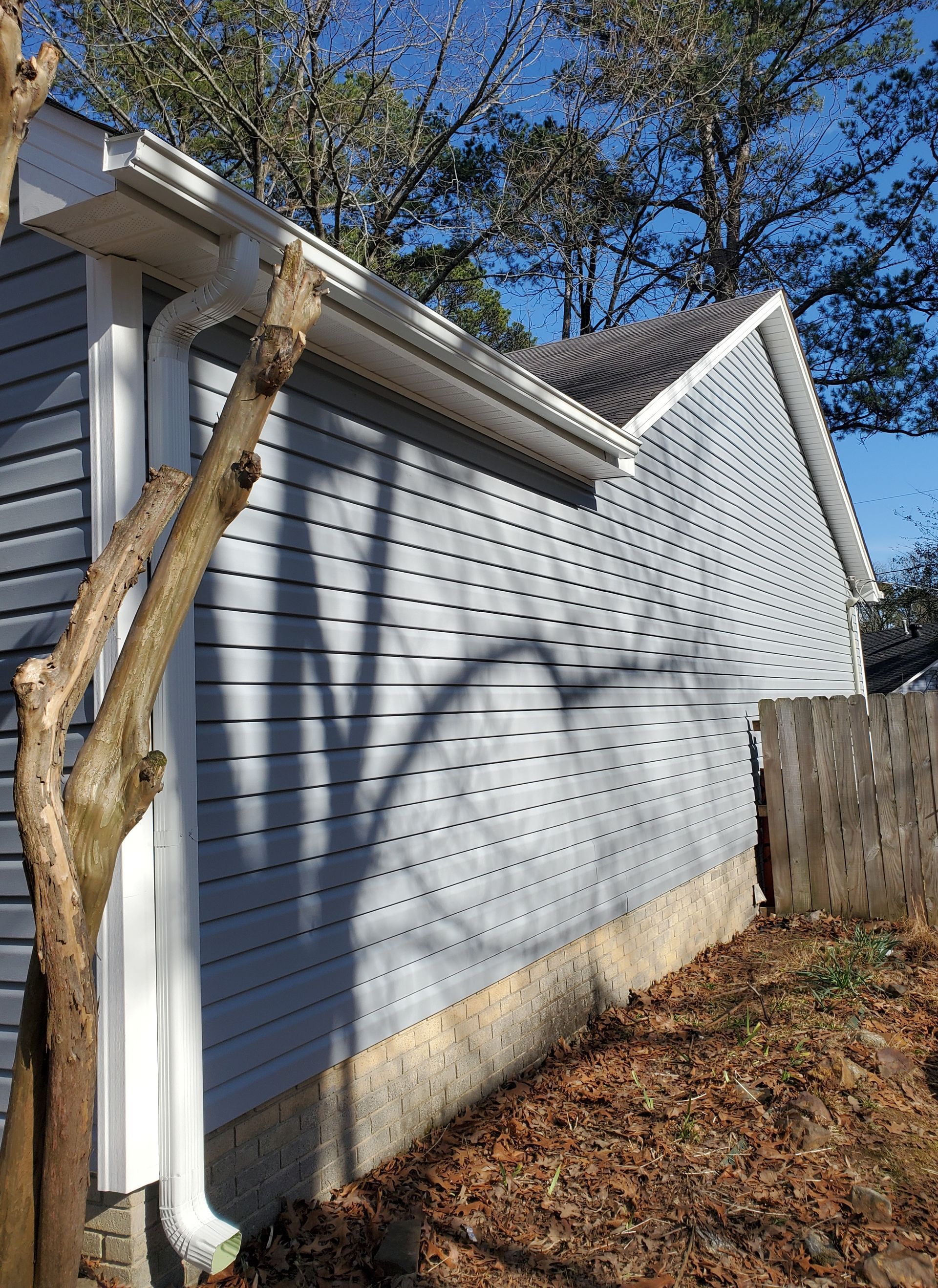 Royal Crest Dutchlap vinyl siding in Blue Gray. 5” seamless gutters and downspouts in white