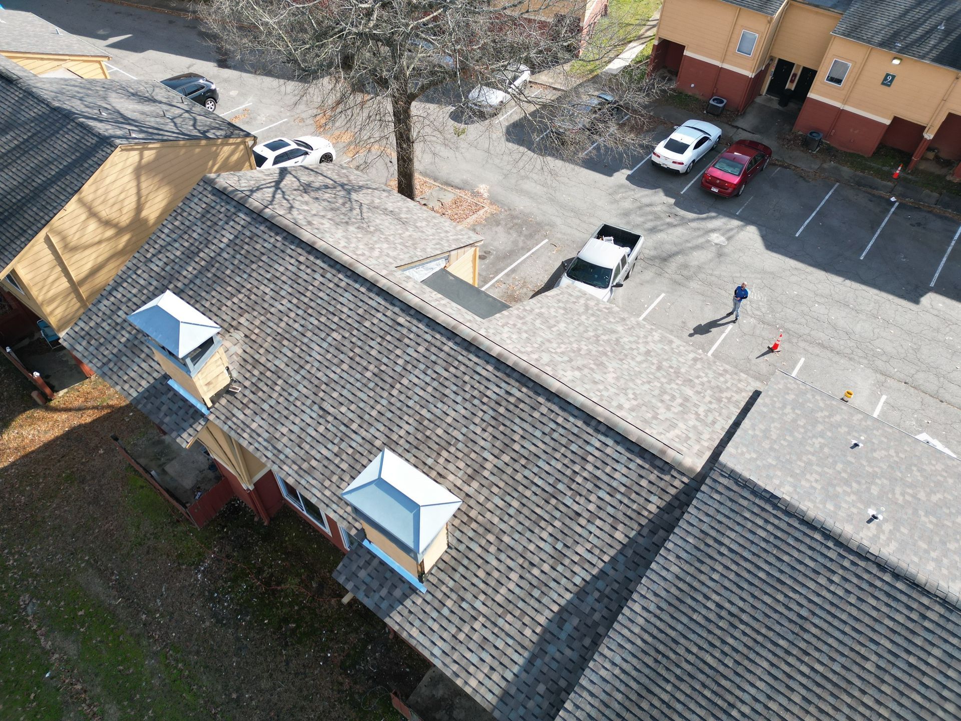 Barrington Hills Apartments in Little Rock, AR. new framing, ceiling joists, and wall stud headers. IKO Cambridge architectural in Weathered Wood