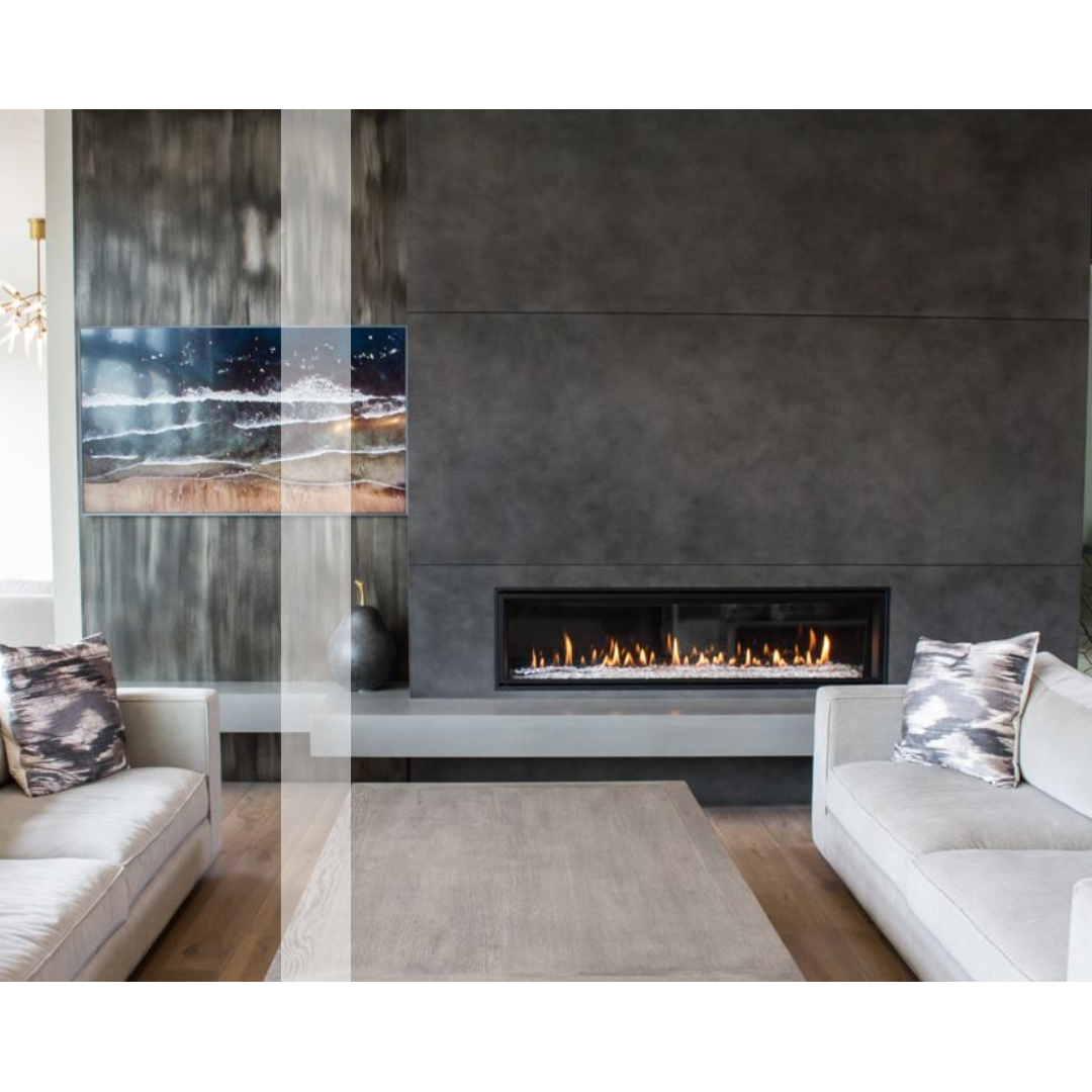 A living room with two couches and a concrete fireplace.