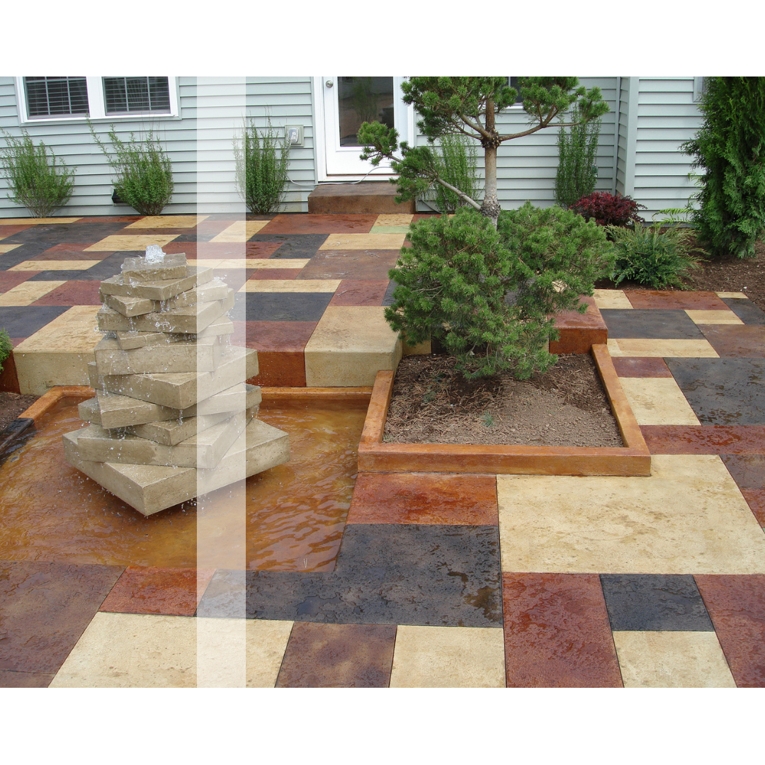 A stained concrete patio with a fountain in the middle of it.