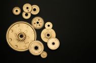 There are many different types of gears on a black background.