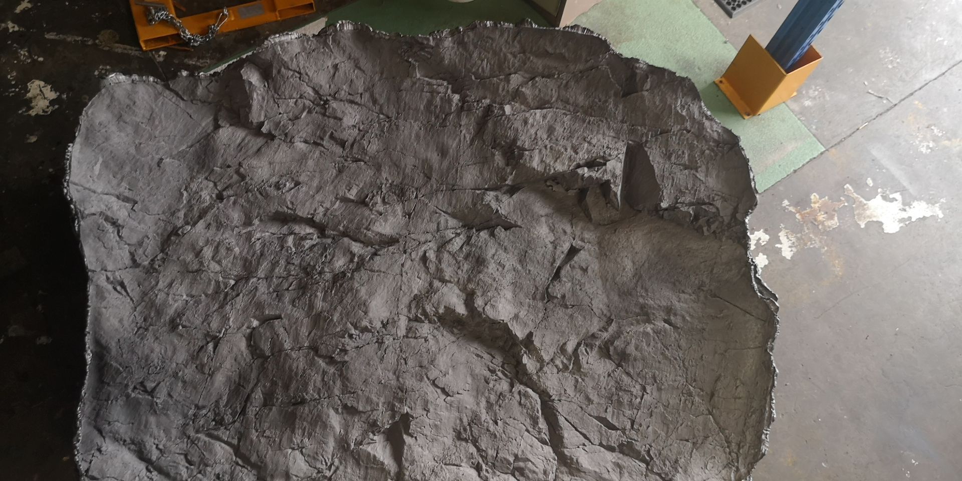 A pile of concrete is sitting on top of a concrete floor.