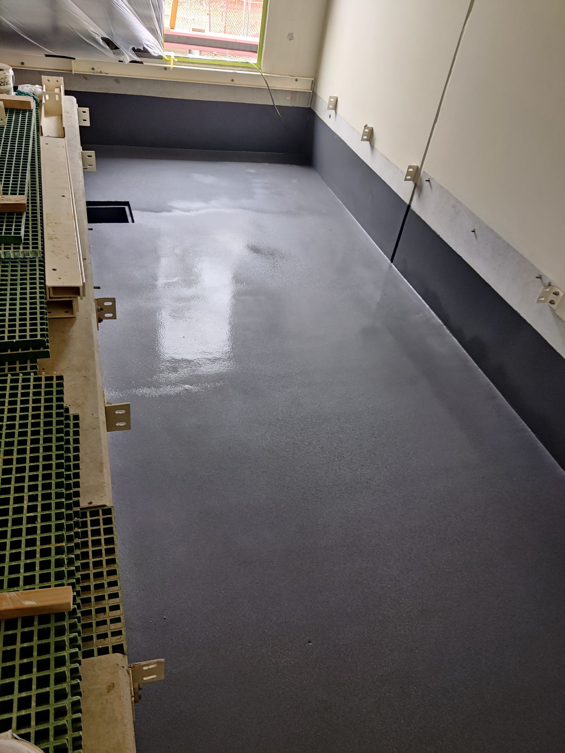 A room with a gray floor and black walls