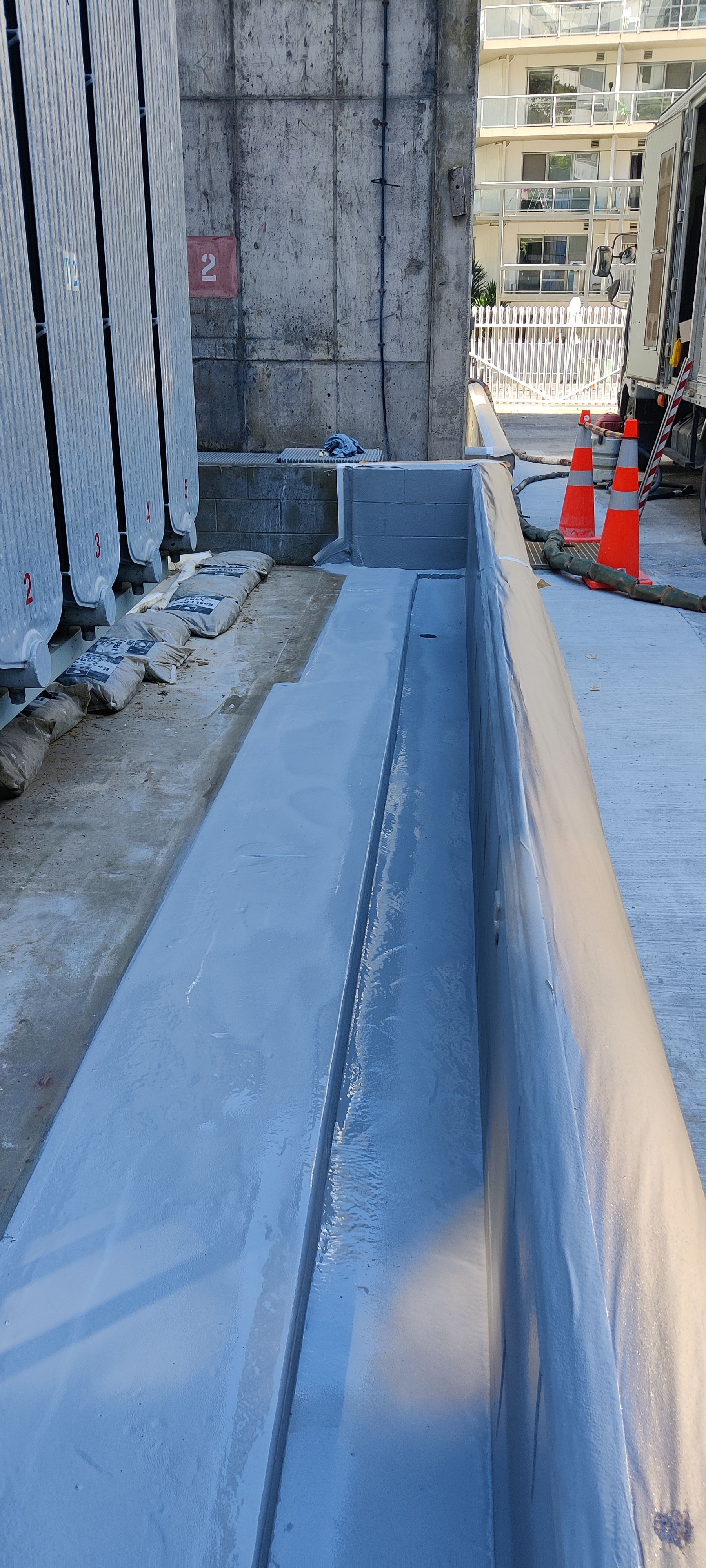 A concrete wall is being built next to a building.