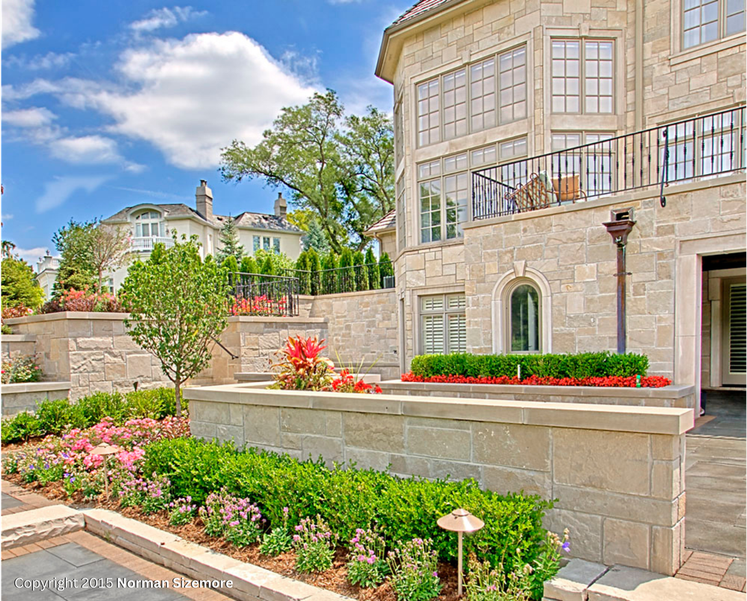 A large house with a lot of windows and flowers in front of it