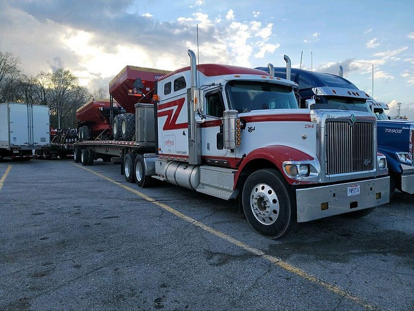 Red and White Semi Truck is Parked in a Parking Lot