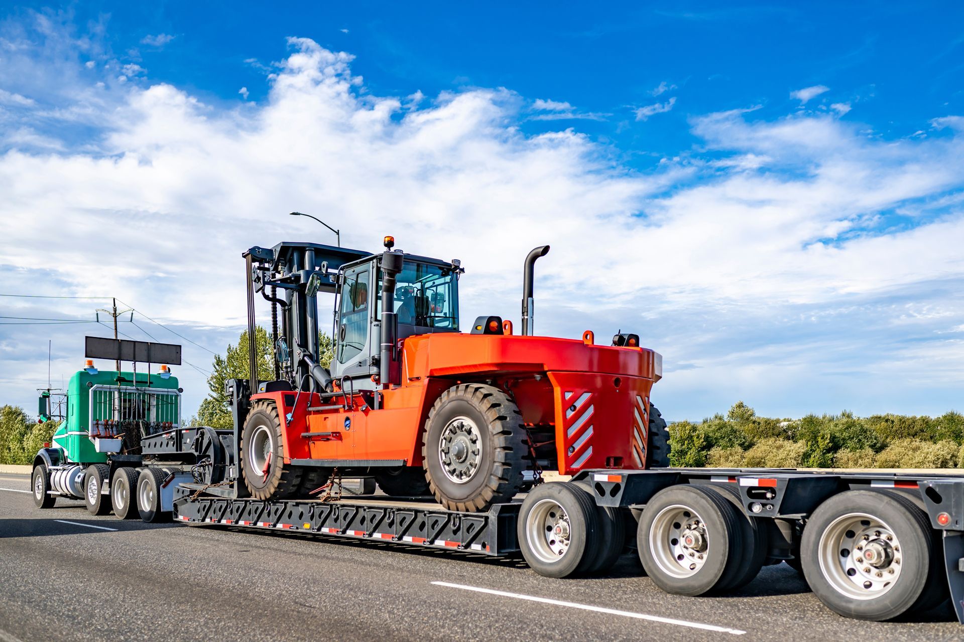 Forklift is Being Transported on a Trailer