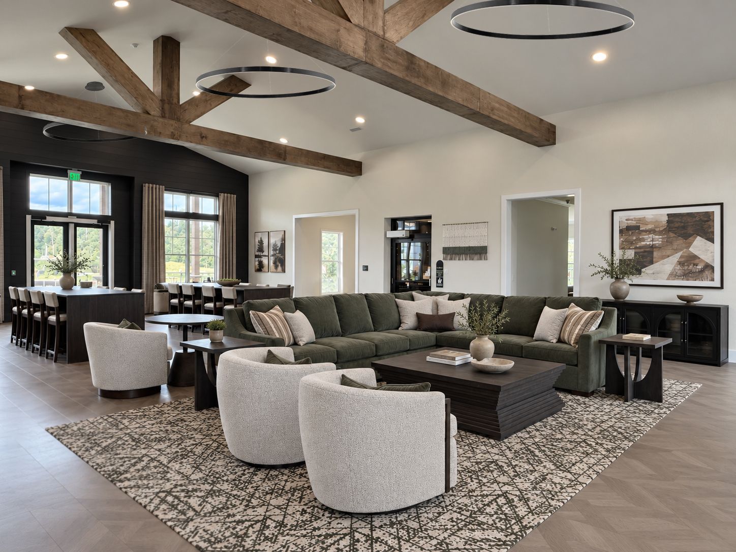 Modern lounge with pool table, sofas, TV, and large windows overlooking a scenic outdoor view