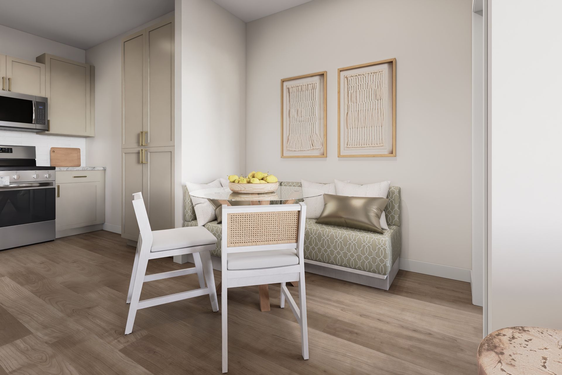 Bright modern kitchen-dining area with white chairs, a small table, and framed wall art.