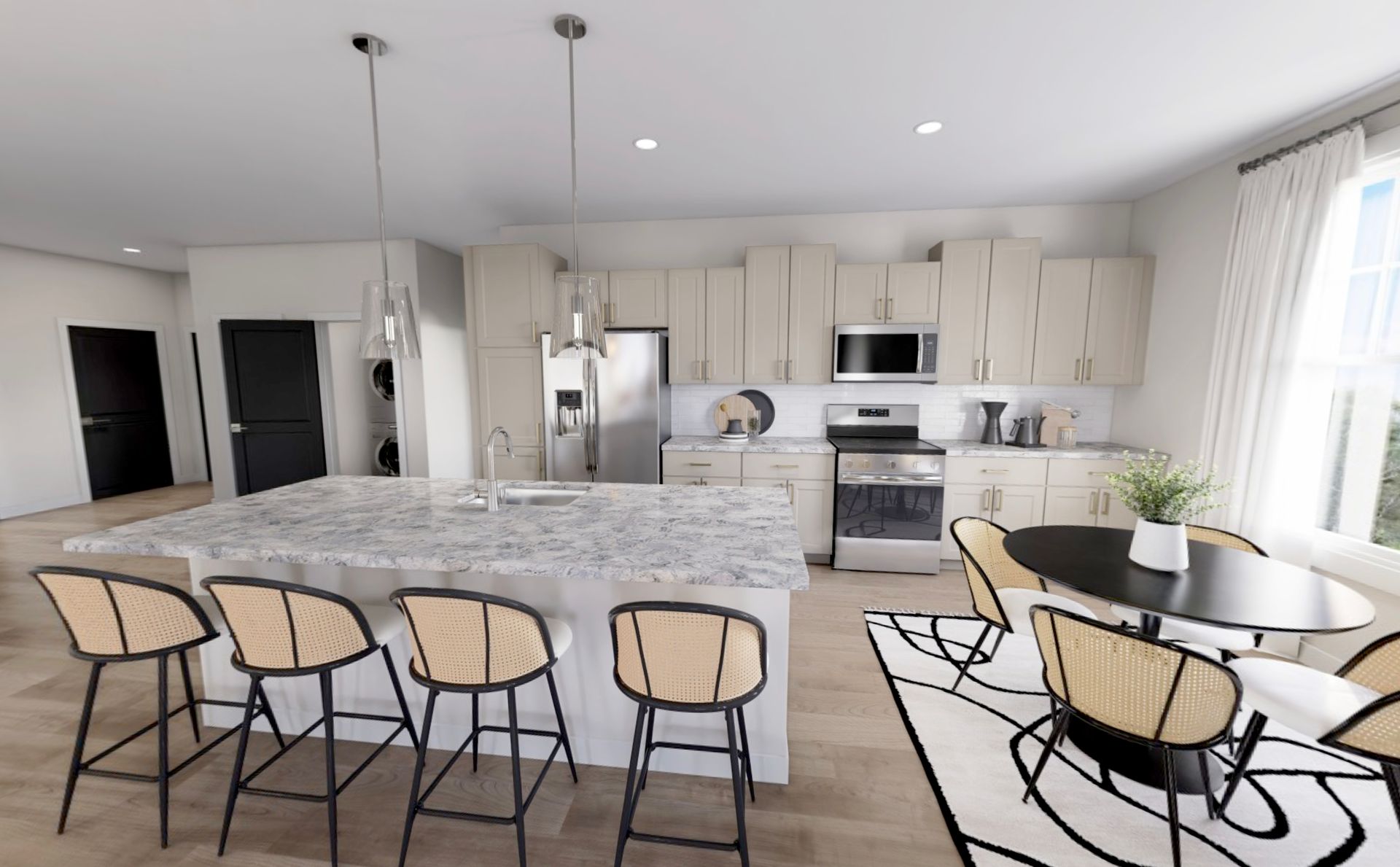 Bright modern kitchen with stone island, bar stools, stainless appliances, and round dining table by windows