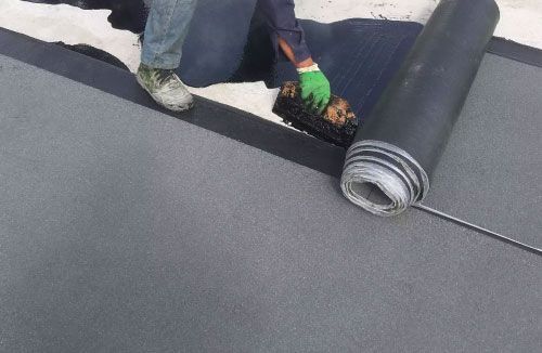 Rooftop comparison graphic labeled “Acrylic vs Silicone” split between white and gray roof surfaces.