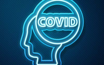 A neon sign of a person 's head with the word covid inside of it.