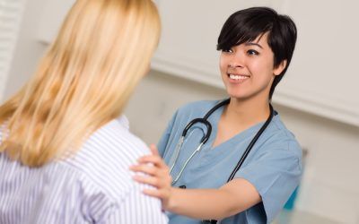 A nurse is talking to a patient in a hospital.