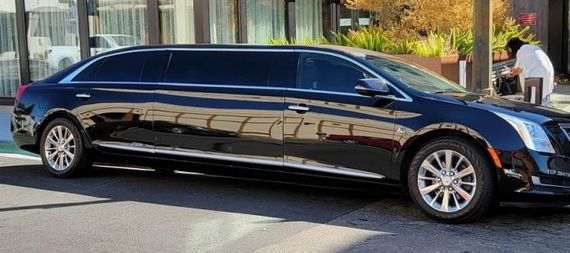 Black stretched limousine on a white background, side view
