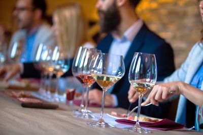 People at a table with wine glasses during a tasting event