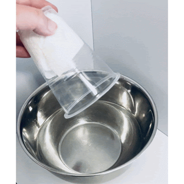 An upside cup being pushed in water to demonstrate that air takes up space