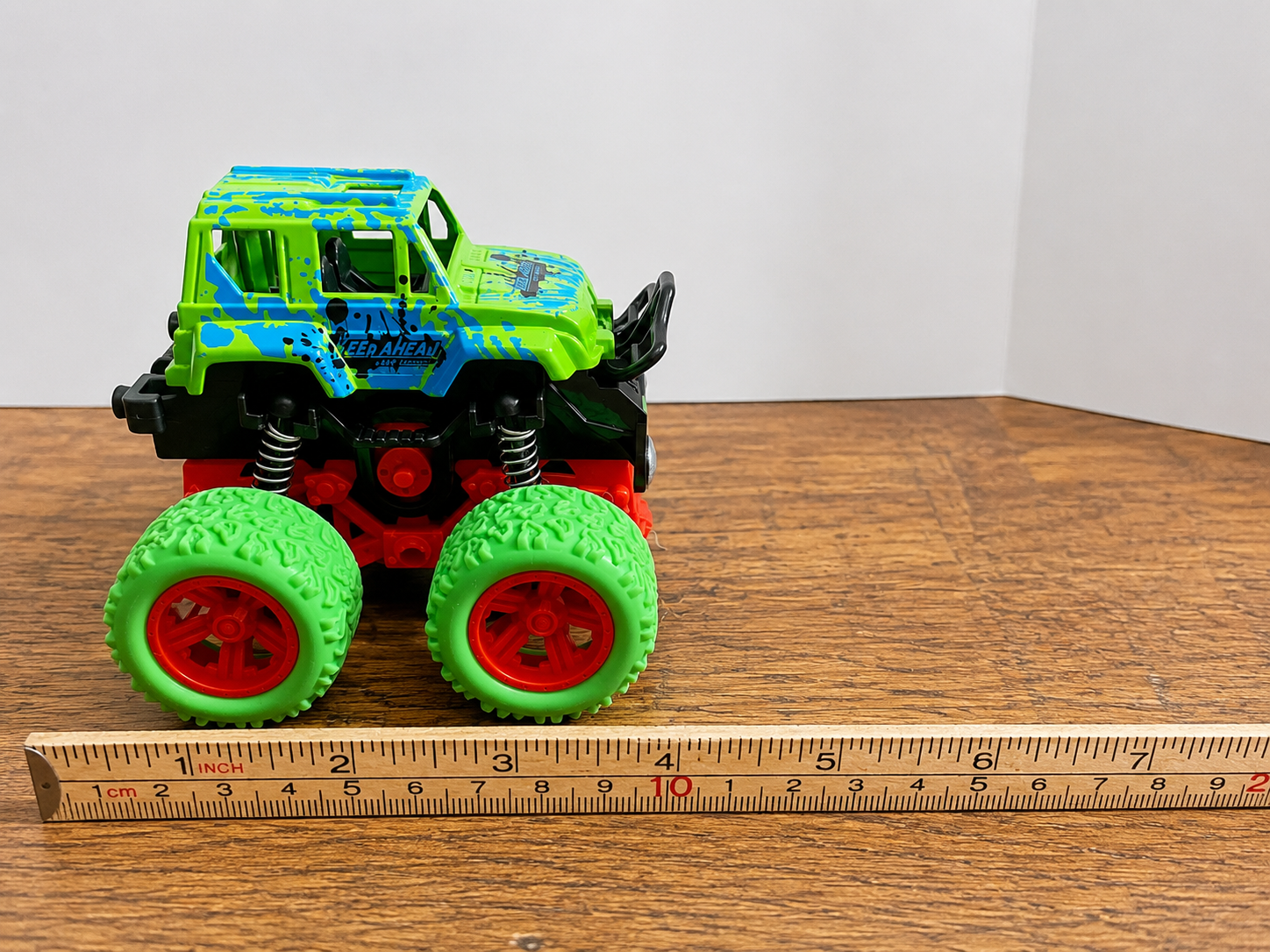 Toy car being pushed next to a meter stick to demonstrate how forces impact the speed of an object.