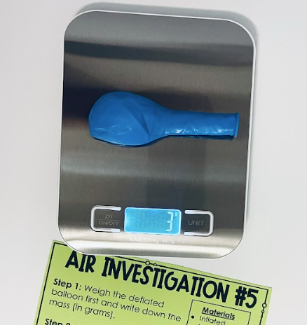A digital scale with a deflated balloon on it.