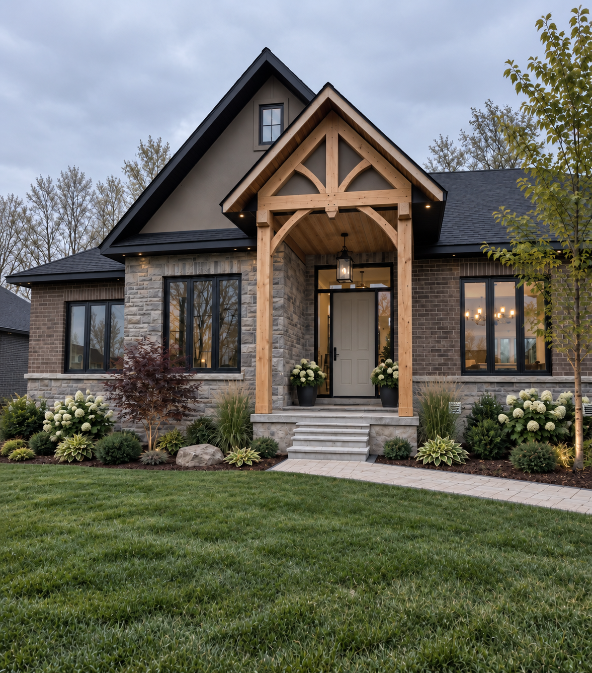 A single-story, stone-faced suburban house with a three-car garage, a covered front entrance, and a landscaped front lawn.