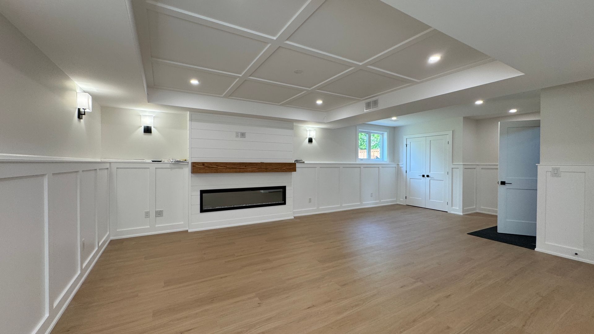 basement reno with wainscoting and ceiling treatment in white