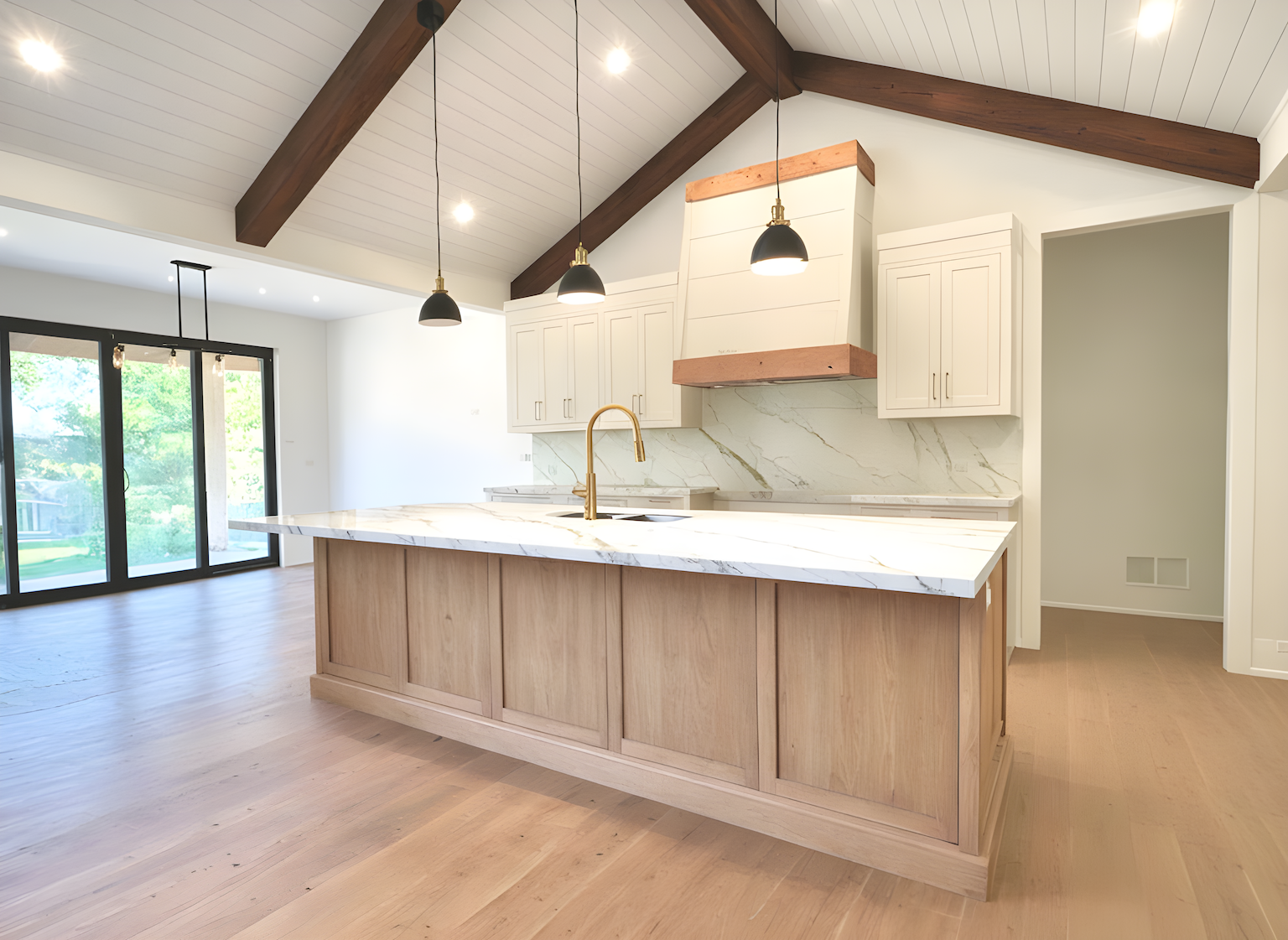kit island with faux rafters and shiplap cieling