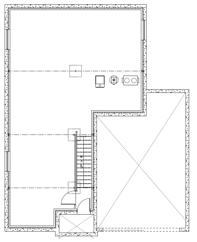 Black-and-white floor plan of a rectangular building with an attached section, featuring a staircase and room layout.