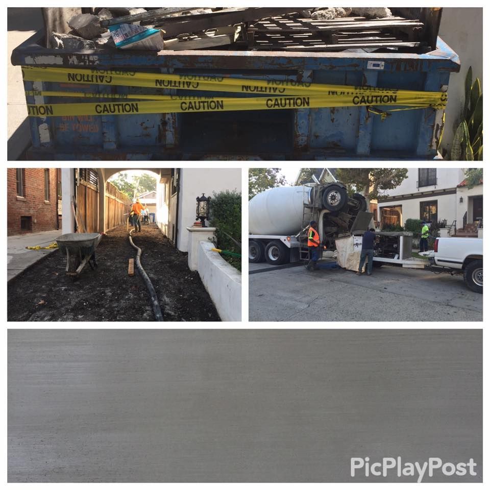 Construction site with dumpster, asphalt paving, and concrete pouring.