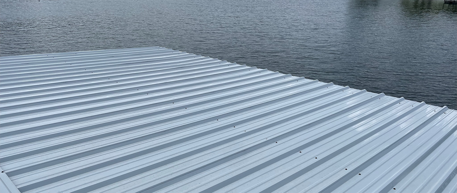 Metal roof beside rippling water under a gray sky