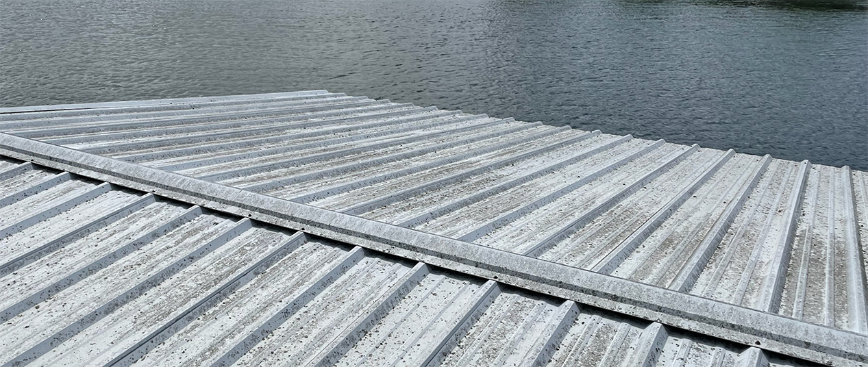 Snow-covered dock extending into a calm lake