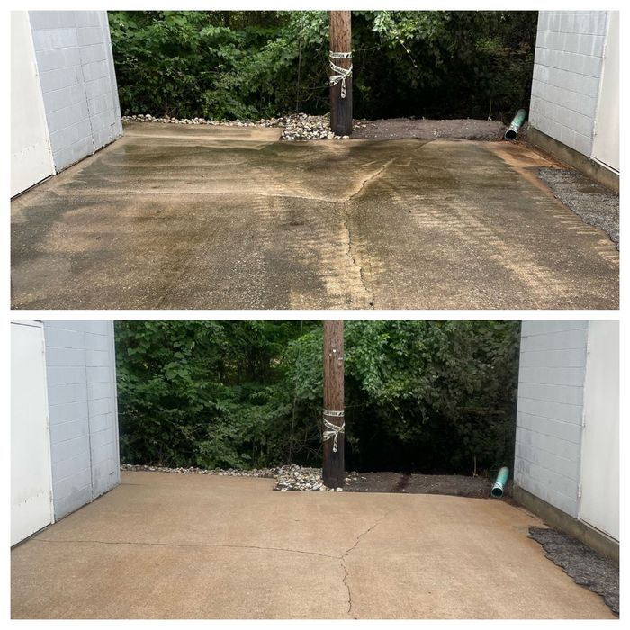 Concrete driveway before and after pressure washing, showing the cleaned lower half.