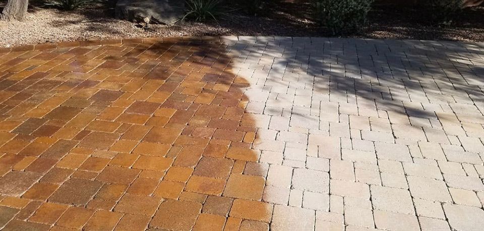 Brick walkway with a wet orange section beside a dry light gray path