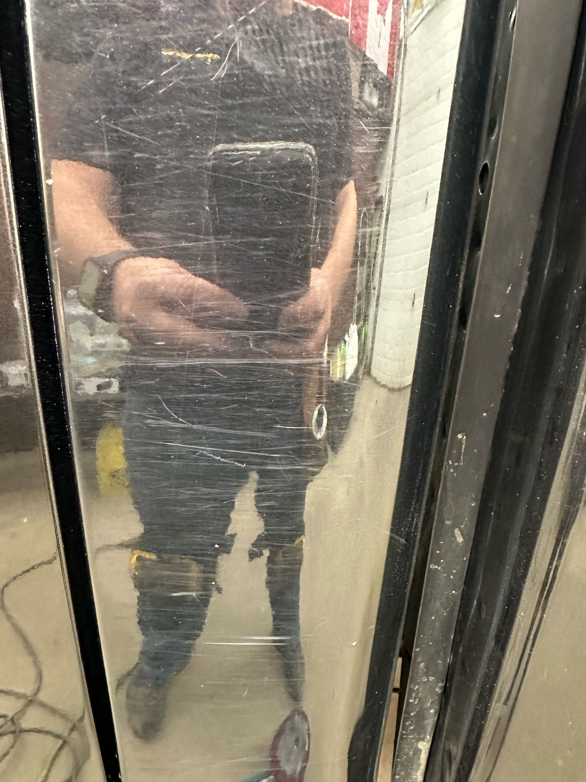 A man is taking a selfie in a mirror.